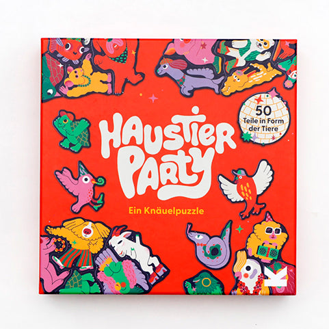 Bunte Puzzle-Verpackung mit fröhlicher Haustierparty, vielen tanzenden Hunden, Katzen und anderen Tieren sowie einer funkelnden Discokugel in der Mitte.