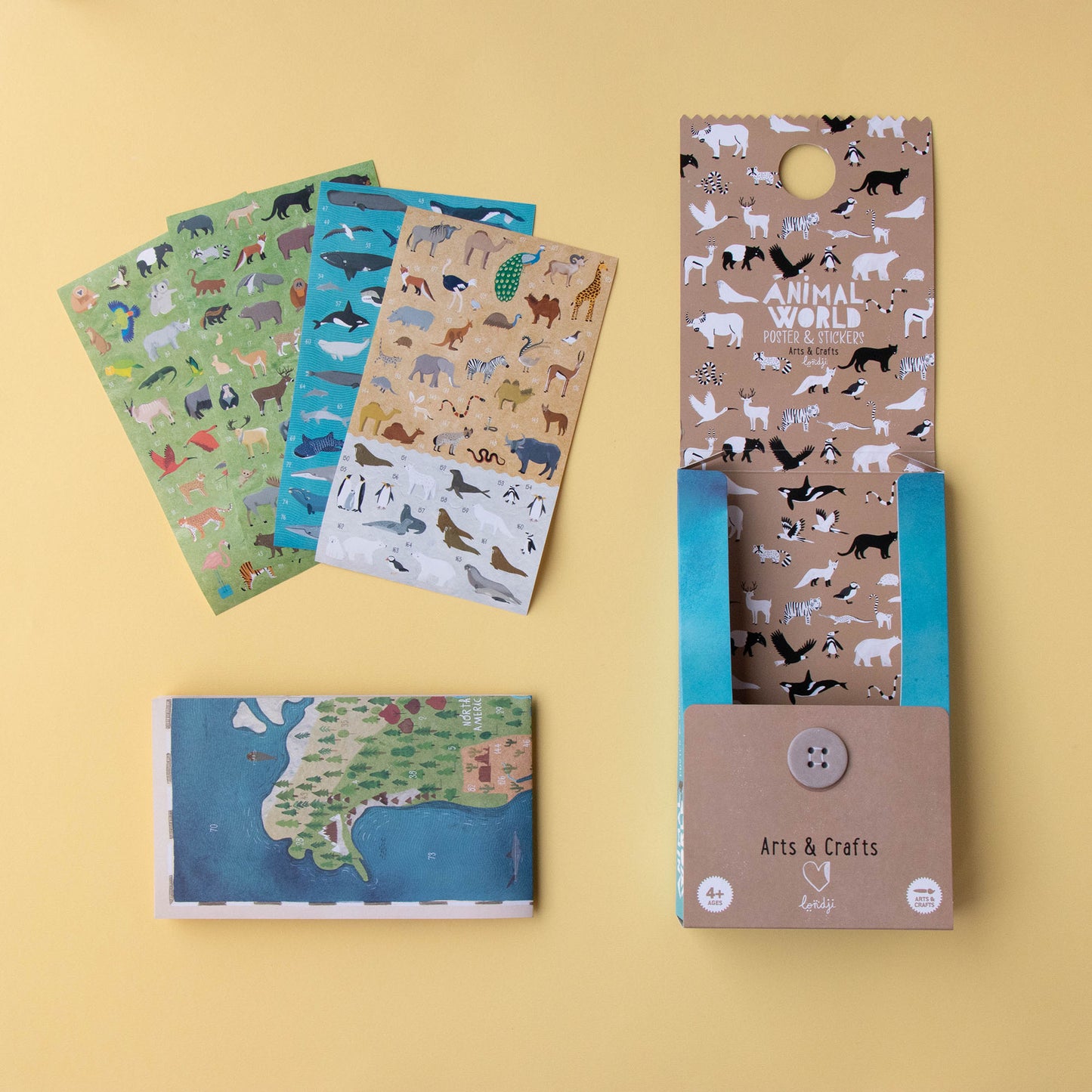 Offenes Londji Bastelset mit zusammengelegtem Weltposter und verschiedenen Tierstickern