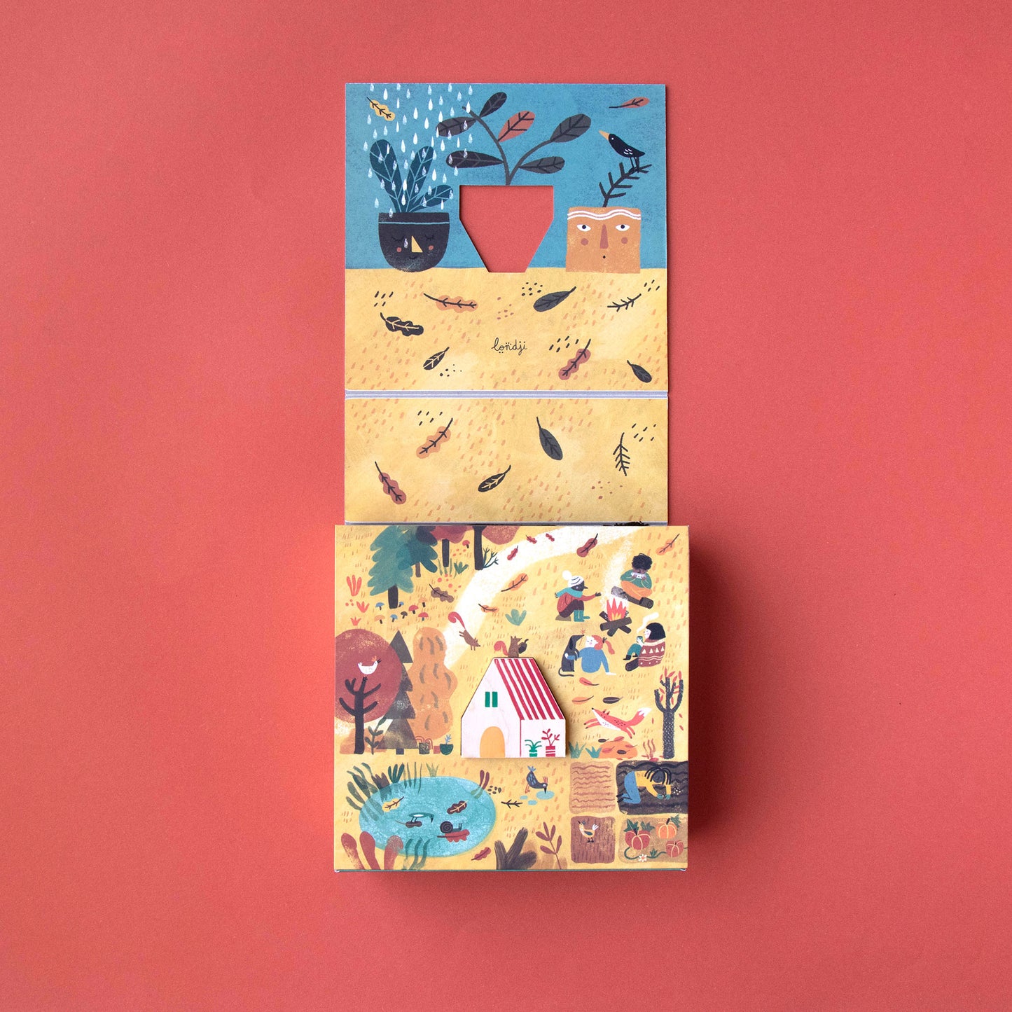 Pocket-Puzzle „AHome for Nature“ von Londji, Box geöffnet, Herbst-Landschaft mit Wald, Garten, Obstbäumen und dem zentralen Holzhaus sichtbar