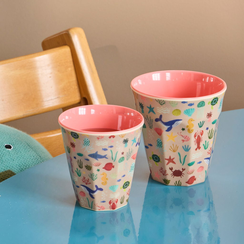Moodbild mit zwei Melaminbechern von Rice in den Größen Small und Medium, rosa mit Meerestier-Motiv, dekorativ auf einem Esstisch platziert